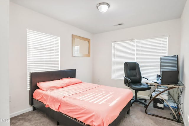 bedroom featuring baseboards, visible vents, and carpet