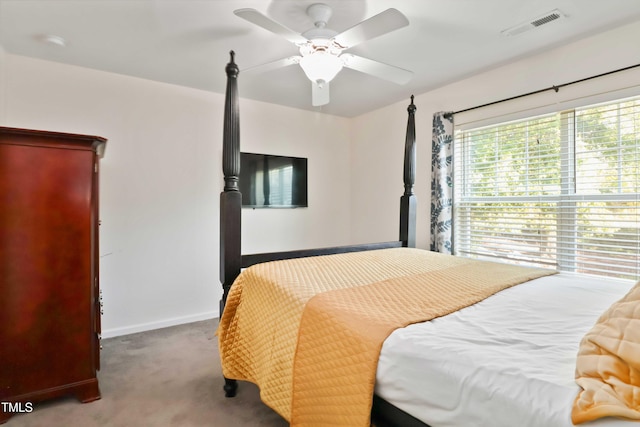 carpeted bedroom with visible vents, baseboards, and ceiling fan