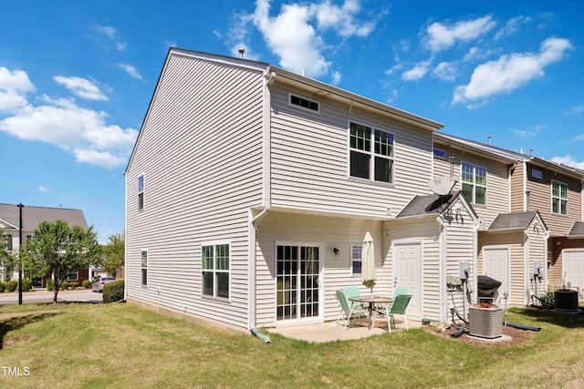 back of house with a patio area, a yard, and central AC