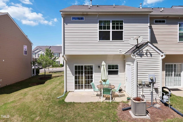rear view of property featuring a yard and a patio