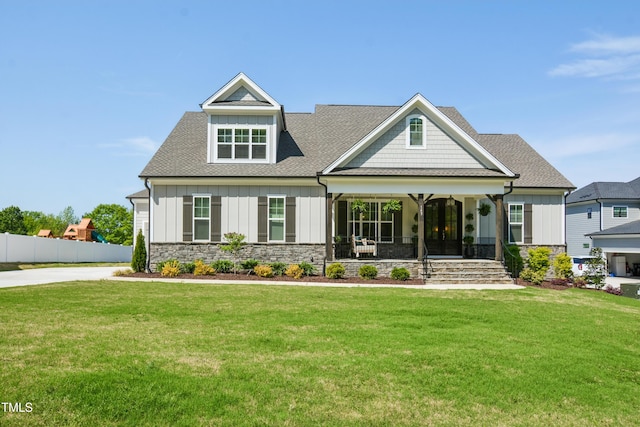143 Sallyport Ct, Raleigh, NC 27603 - craftsman house with board and batten siding, stone siding, and a front lawn