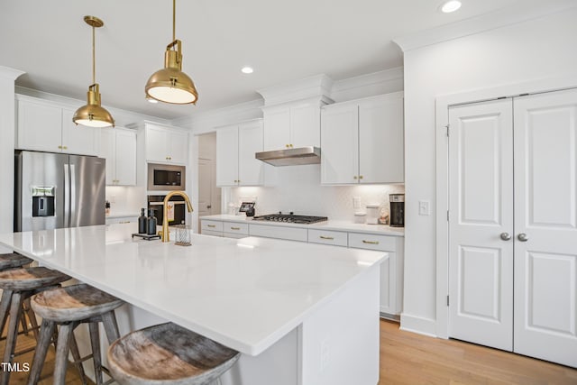 143 Sallyport Ct, Raleigh, NC 27603 - kitchen featuring light wood-style flooring, white cabinets, under cabinet range hood, decorative backsplash, and appliances with stainless steel finishes