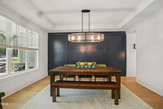 143 Sallyport Ct, Raleigh, NC 27603 - dining area featuring visible vents, baseboards, an inviting chandelier, crown molding, and light wood finished floors