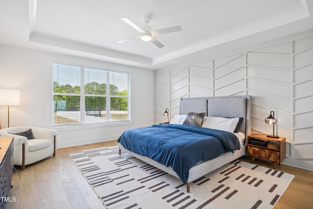 143 Sallyport Ct, Raleigh, NC 27603 - bedroom featuring baseboards, a raised ceiling, wood finished floors, and a ceiling fan