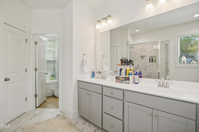 143 Sallyport Ct, Raleigh, NC 27603 - bathroom featuring a shower stall, double vanity, marble finish floor, and a sink