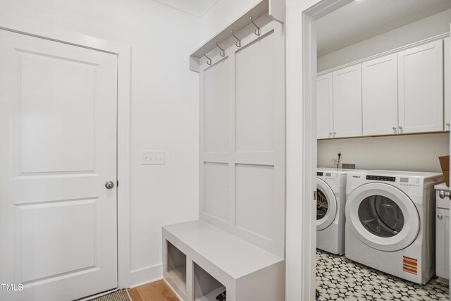 143 Sallyport Ct, Raleigh, NC 27603 - washroom with light floors, cabinet space, and washer and clothes dryer