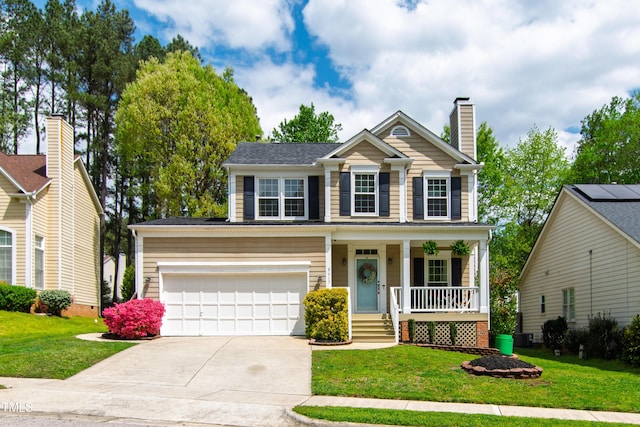 view of front of home with a porch, driveway, a front yard, and a chimney