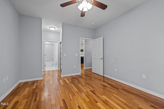 8231 Allyns Landing Way Unit 101, Raleigh, NC 27615 - unfurnished bedroom featuring light wood-style floors, ensuite bath, and a ceiling fan