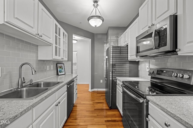 8231 Allyns Landing Way Unit 101, Raleigh, NC 27615 - kitchen with appliances with stainless steel finishes, white cabinets, and light wood-style floors