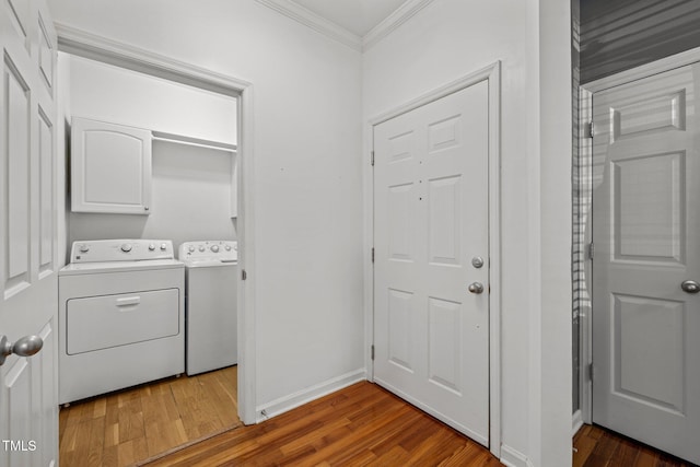 8231 Allyns Landing Way Unit 101, Raleigh, NC 27615 - washroom featuring ornamental molding, separate washer and dryer, wood finished floors, and cabinet space