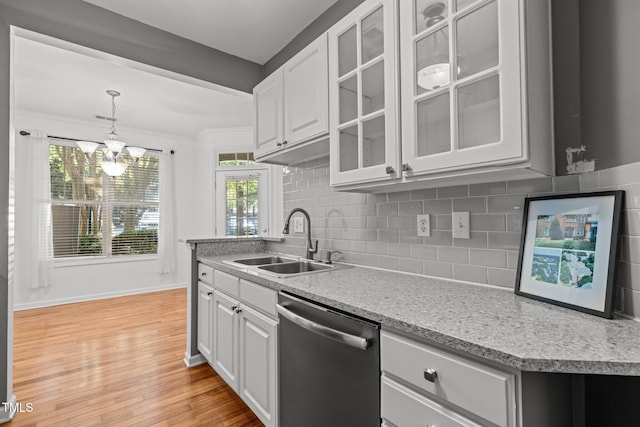 8231 Allyns Landing Way Unit 101, Raleigh, NC 27615 - kitchen featuring stainless steel dishwasher, a chandelier, light wood-style flooring, tasteful backsplash, and glass insert cabinets
