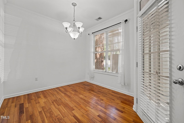 8231 Allyns Landing Way Unit 101, Raleigh, NC 27615 - empty room featuring ornamental molding, a chandelier, and wood finished floors
