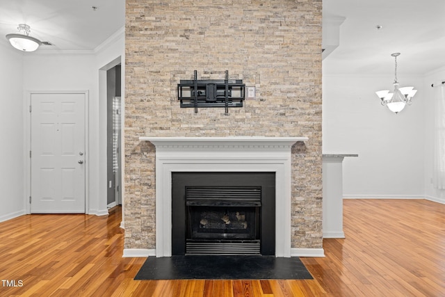 8231 Allyns Landing Way Unit 101, Raleigh, NC 27615 - detailed view of wood finished floors, a chandelier, crown molding, and a fireplace with flush hearth
