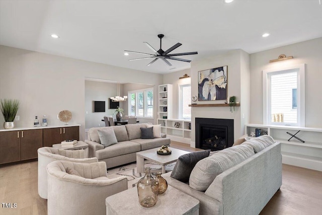 337 Merrywood Dr, Raleigh, NC 27610 - living area with recessed lighting, a glass covered fireplace, and light wood-type flooring