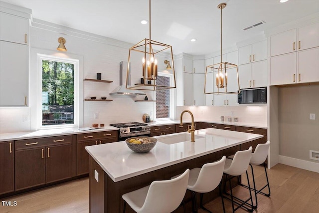 337 Merrywood Dr, Raleigh, NC 27610 - kitchen with white cabinets, a sink, visible vents, dark brown cabinetry, and stainless steel gas range oven