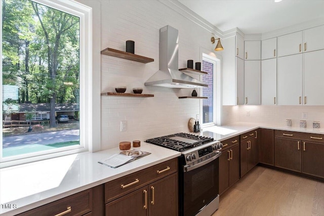 337 Merrywood Dr, Raleigh, NC 27610 - kitchen with wall chimney exhaust hood, open shelves, gas stove, and a healthy amount of sunlight