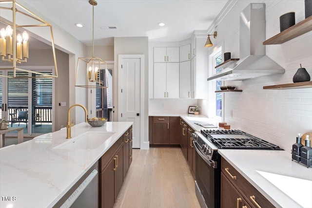 337 Merrywood Dr, Raleigh, NC 27610 - kitchen featuring a sink, an inviting chandelier, wall chimney range hood, open shelves, and appliances with stainless steel finishes