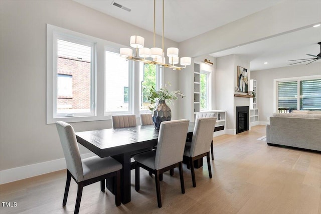 337 Merrywood Dr, Raleigh, NC 27610 - dining space with light wood-type flooring, visible vents, baseboards, and a wealth of natural light