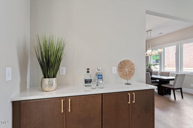337 Merrywood Dr, Raleigh, NC 27610 - bar with light wood-style flooring and an inviting chandelier