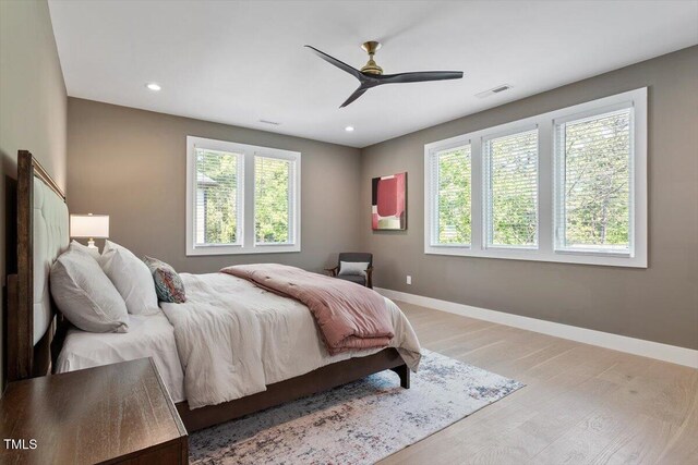 337 Merrywood Dr, Raleigh, NC 27610 - bedroom with light wood-type flooring, visible vents, baseboards, and multiple windows
