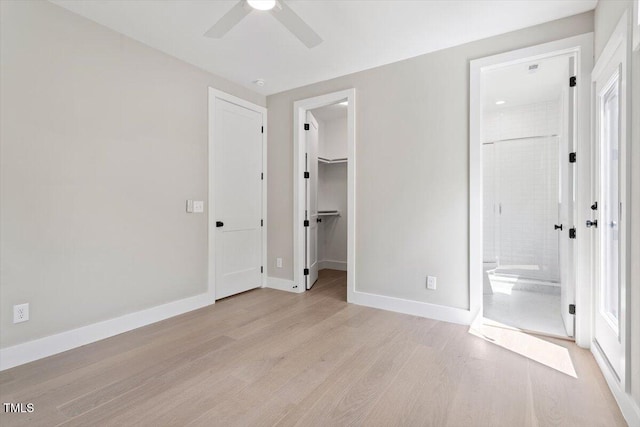 337 Merrywood Dr, Raleigh, NC 27610 - unfurnished bedroom featuring a walk in closet, a closet, ensuite bath, baseboards, and light wood-style flooring