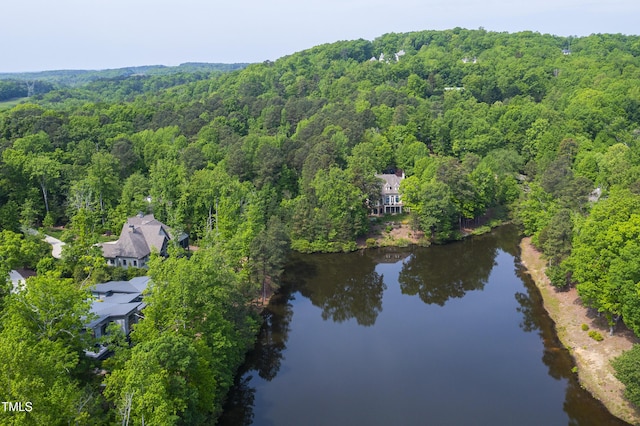 aerial view with a wooded view and a water view