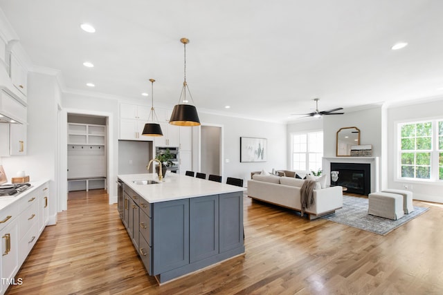 kitchen featuring white cabinets, appliances with stainless steel finishes, and ornamental molding