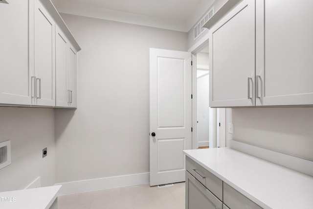 laundry room with electric dryer hookup, cabinet space, baseboards, visible vents, and washer hookup