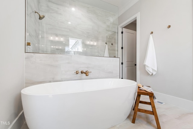 full bath featuring baseboards, a freestanding tub, and tiled shower