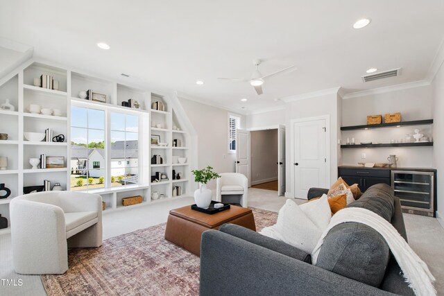 living area with light carpet, wine cooler, visible vents, and ornamental molding
