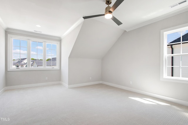 additional living space featuring light colored carpet, ceiling fan, visible vents, and plenty of natural light