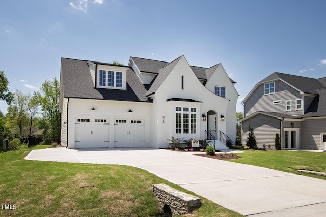 view of front of house featuring roof with shingles, a front yard, and concrete driveway