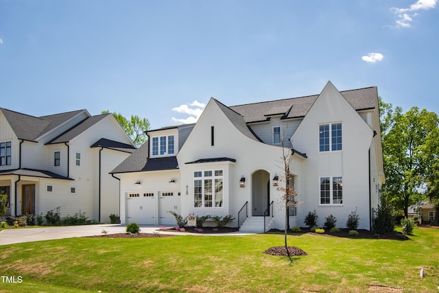 french provincial home featuring a shingled roof, a front lawn, brick siding, and concrete driveway