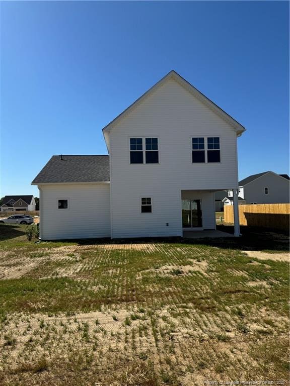back of house with a yard and fence