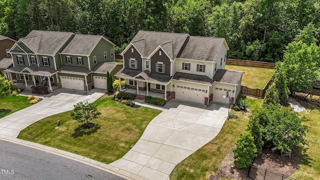 view of front of property featuring covered porch, concrete driveway, and a garage
