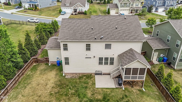 back of house with a residential view, a sunroom, and a patio area