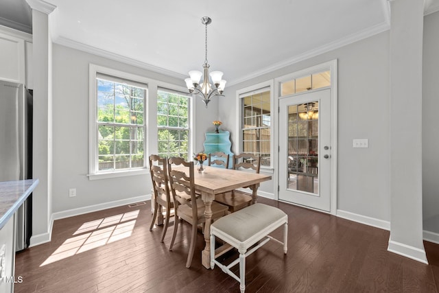 dining area with baseboards, crown molding, a chandelier, and dark wood finished floors