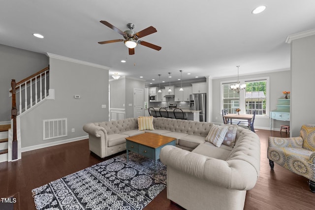 living area featuring ceiling fan, ornamental molding, a chandelier, dark wood-style flooring, and stairs
