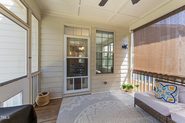 sunroom / solarium with ceiling fan and coffered ceiling