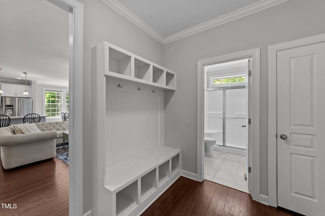 mudroom featuring ornamental molding, dark wood finished floors, and baseboards
