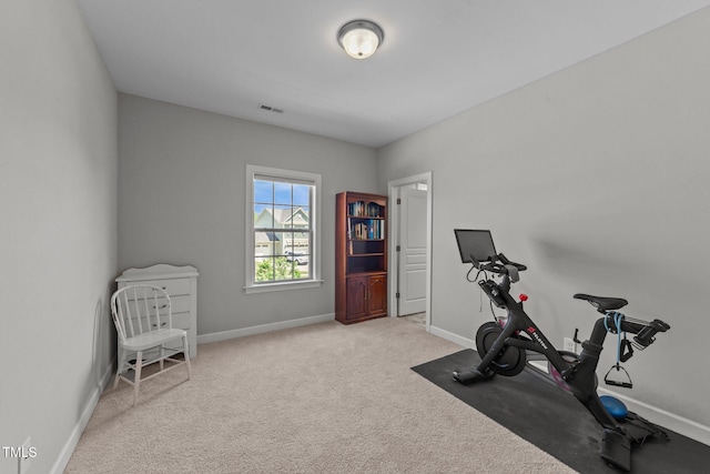 workout area with baseboards and carpet flooring