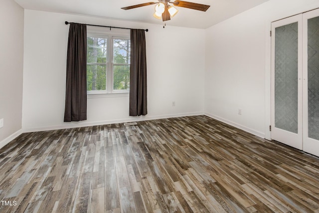 unfurnished room with ceiling fan, wood finished floors, and baseboards