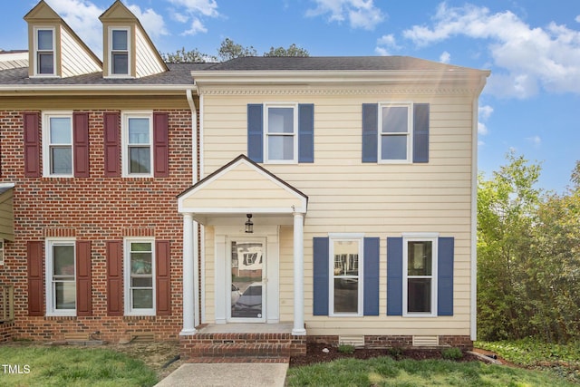 townhome / multi-family property with brick siding