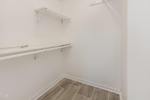 spacious closet featuring wood finish floors