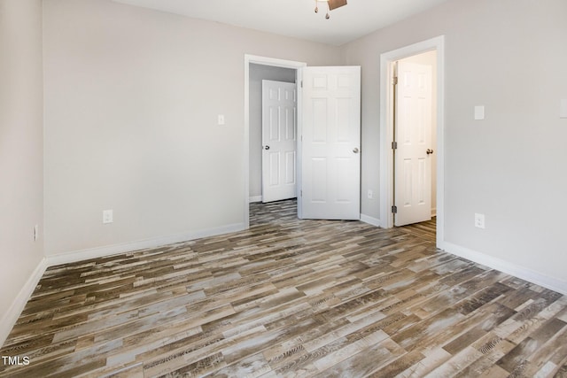 unfurnished bedroom featuring baseboards, a ceiling fan, and wood finished floors