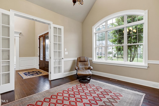 sitting room with french doors, hardwood / wood-style floors, and lofted ceiling
