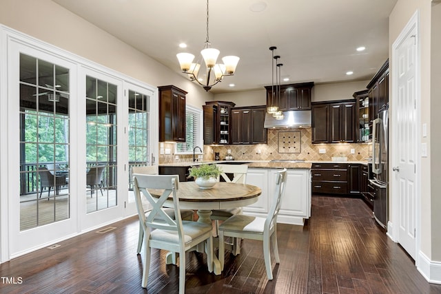 dining area with a chandelier, dark wood-type flooring, and recessed lighting