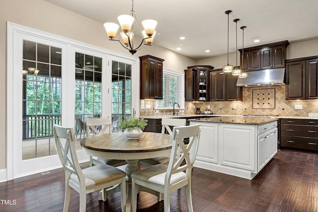 dining space with a chandelier, dark wood-style flooring, and recessed lighting