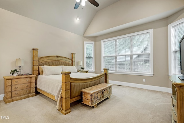 bedroom with multiple windows, vaulted ceiling, baseboards, light colored carpet, and a ceiling fan