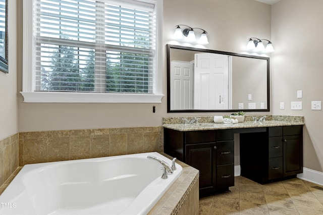 bathroom featuring plenty of natural light, a bath, and double vanity